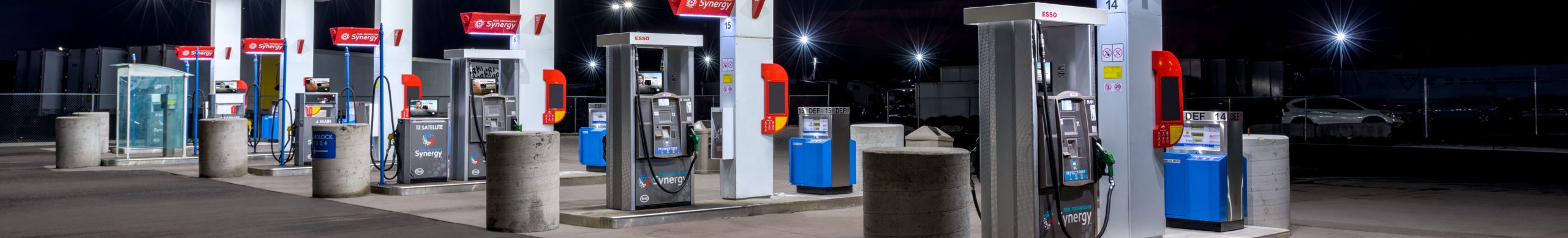 Photo of fuel dispensers beneath an Esso cardlock canopy at night
